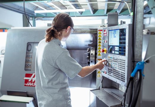 CNC operator setting up a precision machining job